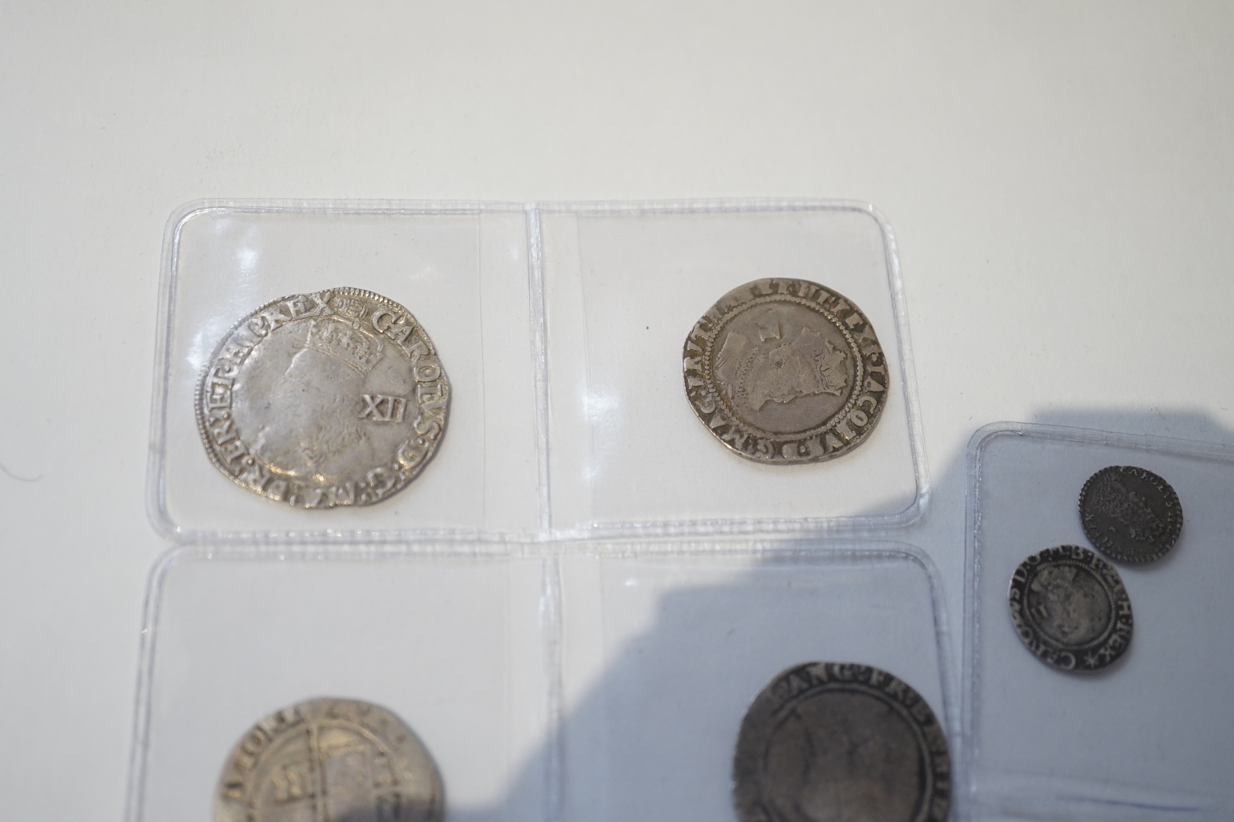 British Tudor and Stuart hammered silver coins, an Elizabeth I shilling and two sixpences, a James I sixpence, two Charles I shillings, a Charles II penny, first issue, 1660-62, (S3311) VF, twopence (S3310) (8)